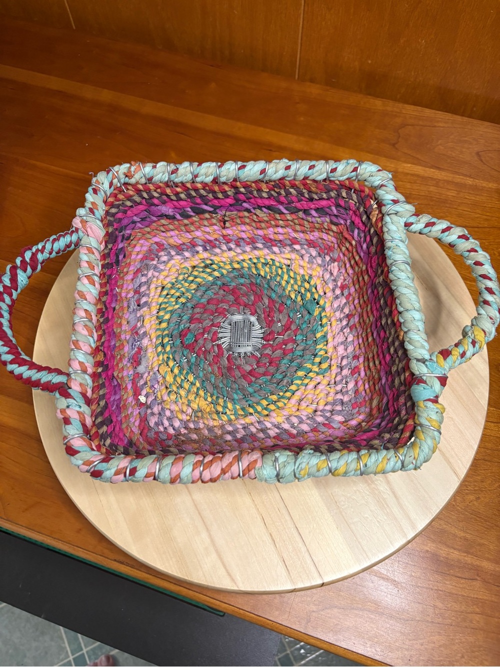 handcrafted square storage basket featuring vibrant concentric rings